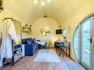 a living room with a blue couch and a table at Heather - Uk34841 in Straiton