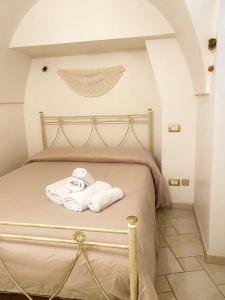 a bedroom with a bed with towels on it at Nonno Pasquale house in Locorotondo