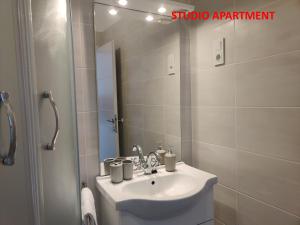 a bathroom with a sink and a mirror at Apartments Miraflor, city center in Crikvenica +31 photos