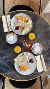 a black table with plates of food on it at Hotel Marcellin in Beaulieu-sur-Mer