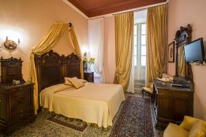 ルッカにあるRelais San Lorenzoの大きなベッドとテレビのある寝室