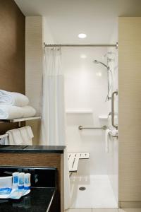 a hotel bathroom with a shower and a sink at Fairfield Inn & Suites by Marriott Columbus Dublin in Dublin