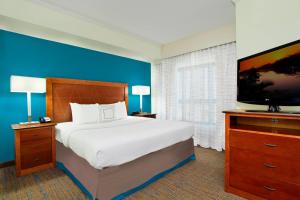 a bedroom with a bed and a flat screen tv at Residence Inn DFW Airport North/Grapevine in Grapevine