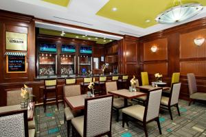 a restaurant with tables and chairs and a bar at Residence Inn DFW Airport North/Grapevine in Grapevine