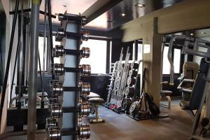 a gym with a bunch of equipment in it at Hotel Panamericano Bariloche in San Carlos de Bariloche