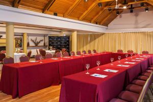 a conference room with red tables and chairs at Hotel Panamericano Bariloche in San Carlos de Bariloche