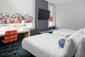 A bed or beds in a room at Aloft El Paso Downtown