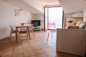 a kitchen and living room with a table and chairs at Vila Nada in Prigradica