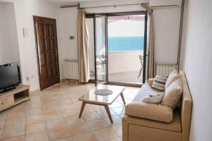 a living room with a couch and a view of the ocean at Vila Nada in Prigradica