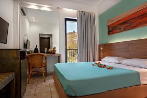 A bed or beds in a room at Hotel Pavlou