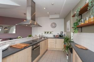 a large kitchen with a sink and a stove at Pass the Keys Lovely apartment in Leeds centre in Leeds