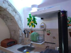 a kitchen with a sink and a counter top at The little house of Ely in Siracusa