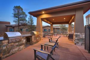 an outdoor patio with a grill and picnic tables at Residence Inn by Marriott Sedona in Sedona