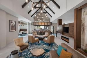 a living room with a couch and chairs at Residence Inn By Marriott Jacksonville-Mayo Clinic Area in Jacksonville