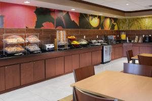 a restaurant with a counter with food on it at Fairfield Inn & Suites by Marriott Dallas Plano The Colony in The Colony