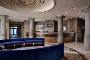 a lobby with a blue couch and a bar at Marriott Vacation Club® at Custom House, Boston   in Boston