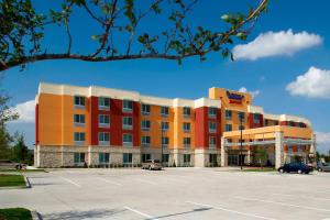 a hotel with a parking lot in front of it at Fairfield Inn & Suites by Marriott Dallas Plano The Colony in The Colony