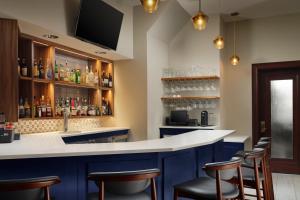 a bar with blue cabinets and bar stools at Marriott Vacation Club® at Custom House, Boston   in Boston