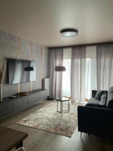 a living room with a couch and a table at GOLD Apartment Centrum garaż in Gliwice