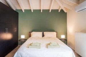 a bedroom with a large bed with two pillows on it at Inalia Modern House in Lefkimmi
