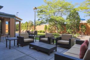 a group of chairs and tables on a patio at Courtyard by Marriott Flint Grand Blanc in Flint