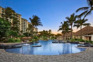 a swimming pool at a resort with palm trees at Marriott's Ko Olina Beach Club in Kapolei