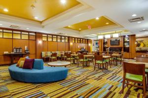 a lobby of a hotel with tables and chairs at Fairfield Inn & Suites Palm Coast I-95 in Palm Coast