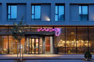 a building with a macy sign in front of it at Moxy Kaunas Center in Kaunas