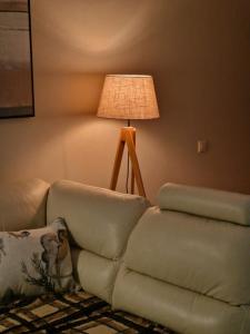 a living room with a couch and a lamp at Apartament Marzanna w Willi na Klifie in Rewal +40 photos