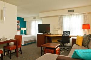 a hotel room with a bed and a living room at Residence Inn Hartford Manchester in Manchester