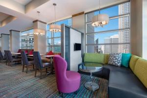 a living room with a couch and a table and chairs at Residence Inn by Marriott Charlotte City Center in Charlotte