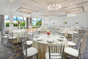 a banquet hall with tables and chairs and chandeliers at Courtyard by Marriott Boston Cambridge in Cambridge