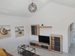a living room with a flat screen tv on a wall at Villa Toledo in Tías