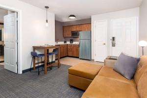 a living room with a couch and a kitchen at Residence Inn by Marriott Boston Brockton/Easton in Brockton