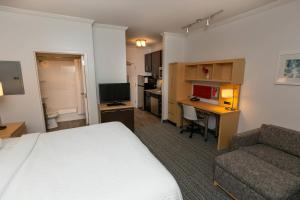 a hotel room with a bed and a desk and a couch at TownePlace Suites by Marriott Bowling Green in Bowling Green