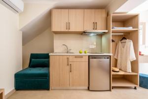 a small kitchen with a green chair in a room at Pargabella apartments in Parga +39 photos