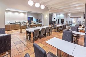 a restaurant with tables and chairs and a kitchen at Residence Inn by Marriott Laredo Del Mar in Laredo
