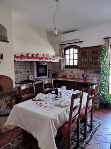 a kitchen with a table with a white table cloth at Villa avec piscine privée in Allauch