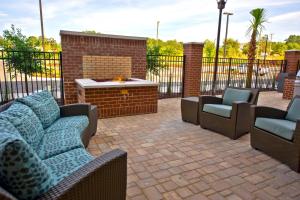 a patio with three chairs and a fire pit at Residence Inn by Marriott Columbia West/Lexington in West Columbia