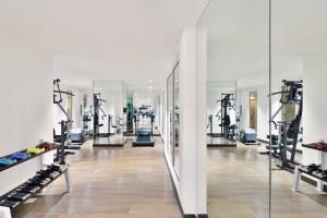 a gym with rows of tread machines and mirrors at Fairfield by Marriott Bengaluru Whitefield in Bangalore