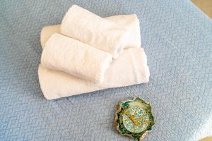 a pile of towels and a ring on a table at Pargabella apartments in Parga