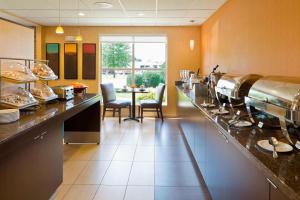 a kitchen with a counter with food on it at Residence Inn by Marriott Cedar Rapids in Cedar Rapids