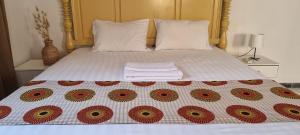 a bed with a white bedspread with polka dots at Le k in Nouakchott