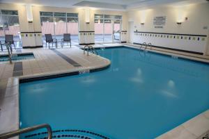 a large swimming pool with blue water at Fairfield Inn & Suites Lewisburg in Lewisburg