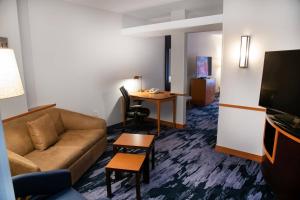 a living room with a couch and a table at Fairfield Inn & Suites Lewisburg in Lewisburg