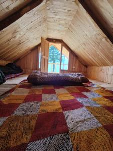 a large bed in a room with an attic at Deep In Woods in Jibhi