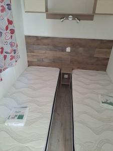 a room with two beds and a table in it at A la ferme dans le Luberon 
