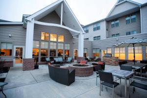 a patio with tables and chairs in front of a building at Residence Inn Columbus in Columbus