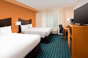 a hotel room with two beds and a flat screen tv at Fairfield Inn & Suites-Washington DC in Washington, D.C.