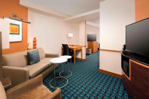 a living room with a couch and a flat screen tv at Fairfield Inn & Suites-Washington DC in Washington, D.C.